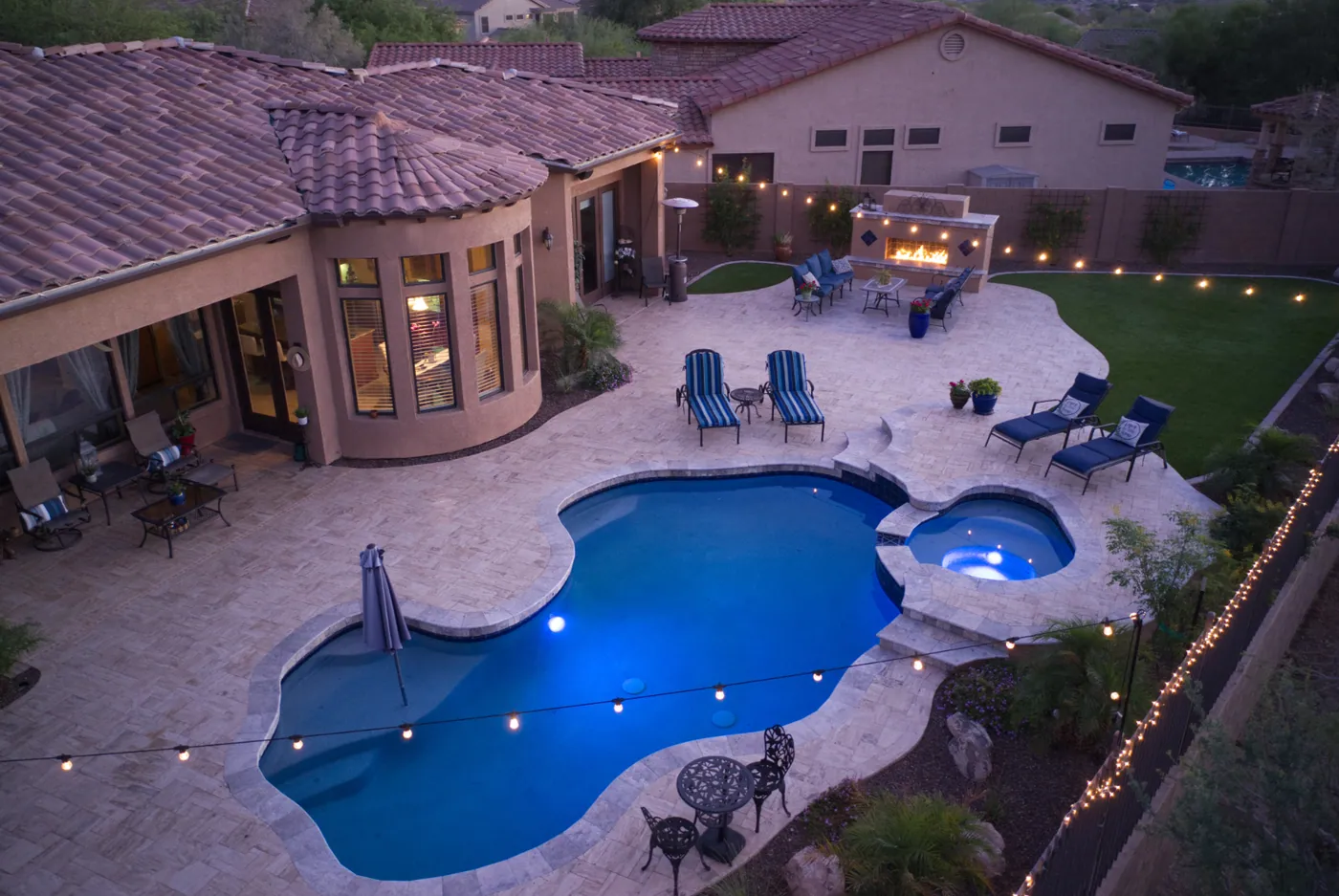 Aerial twilight photograph of a home with a swimming pool