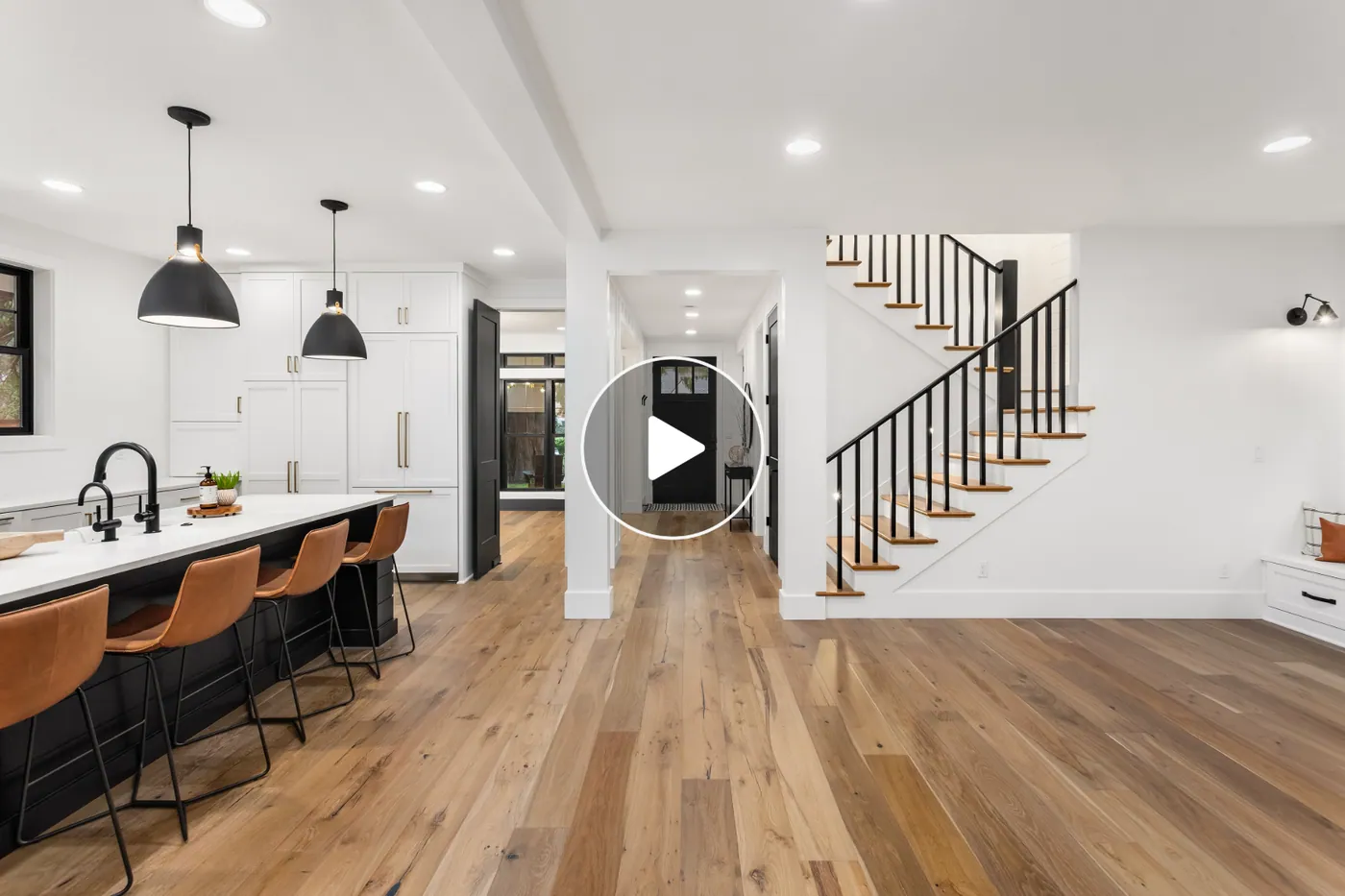 Real estate video walkthrough of a modern kitchen, entryway, and staircase