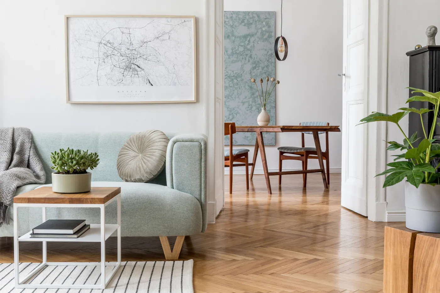 Staged sitting area and dining area with hardwood floors and natural light